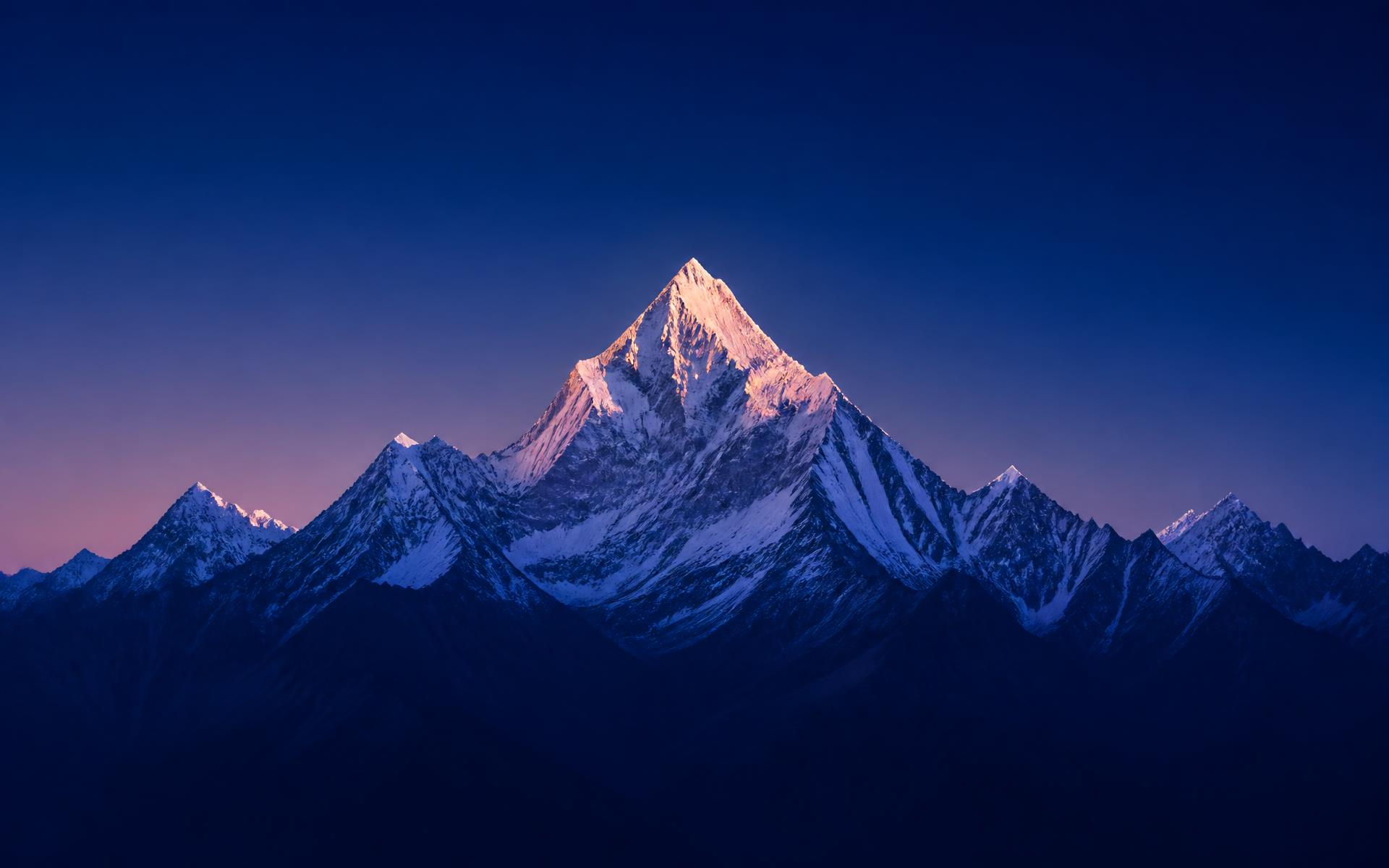 Snow-capped mountain range at sunrise